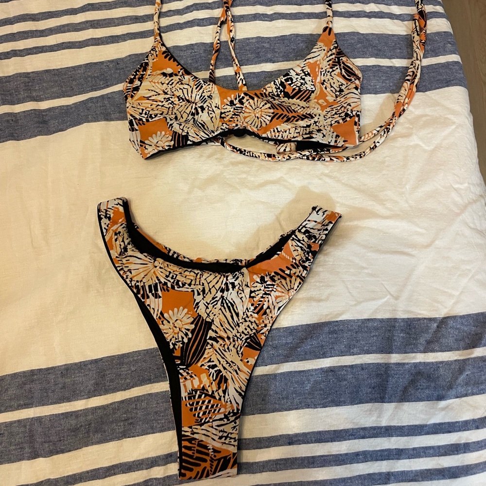 Reversible coral orange tribal bikini to black bikini